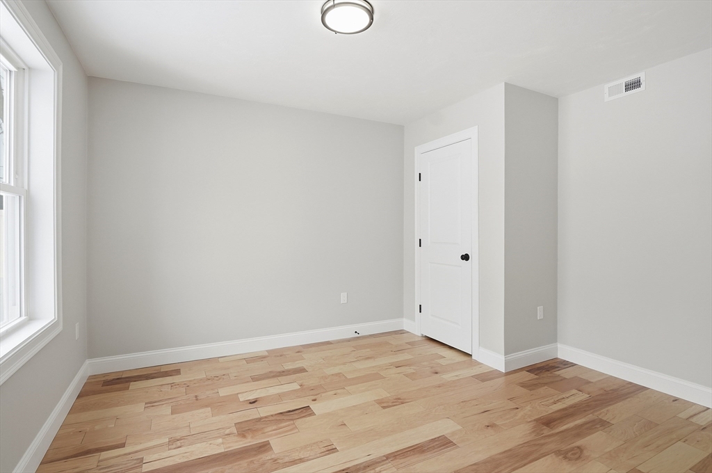 12 Benham Street Worcester, MA 01604 - Photo 10 of 26 a view of empty room with wooden floor