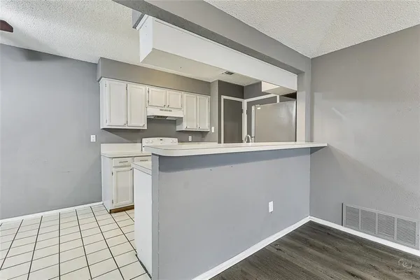 a kitchen with stainless steel appliances a sink stove and cabinets