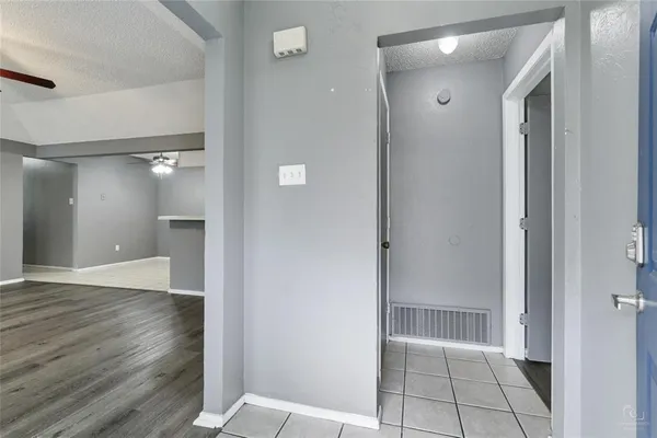 a view of a hallway with wooden floor