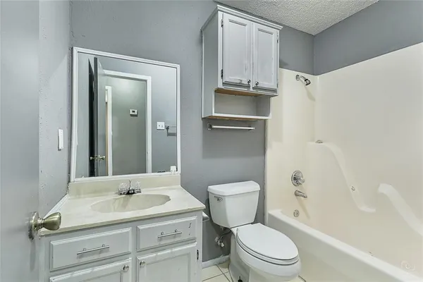 a bathroom with a sink toilet vanity and tub