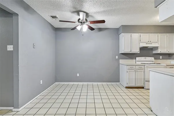 a view of kitchen with a sink cabinets and window