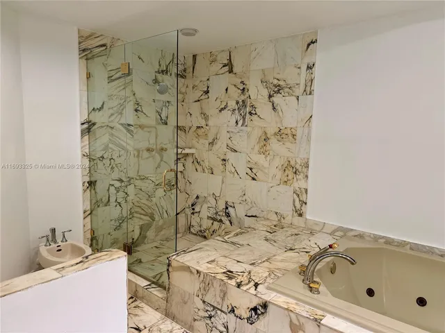 a bathroom with a bathtub and shower