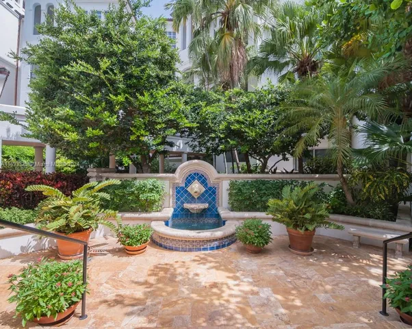 a view of a park with plants and large trees