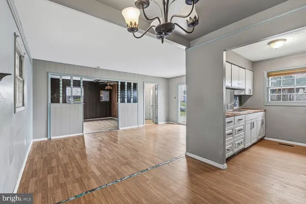 a view of a kitchen with furniture and wooden floor