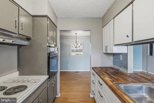a kitchen with a stove and a refrigerator