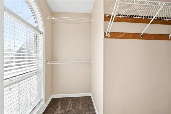 a view of walk in closet with wooden floor