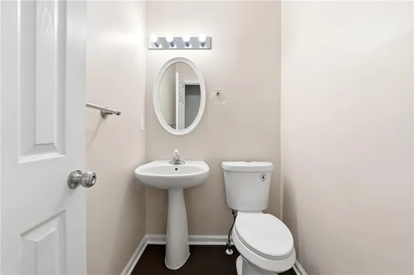 a white toilet sitting next to a white sink