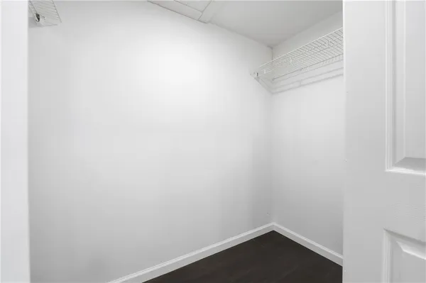 a view of a kitchen with white cabinets