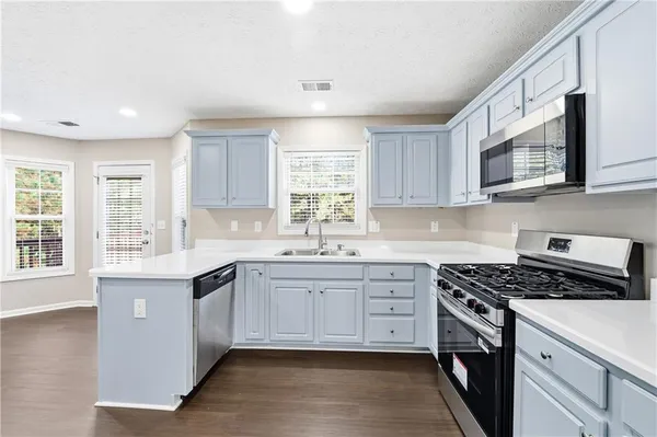a kitchen that has a sink and a stove in it