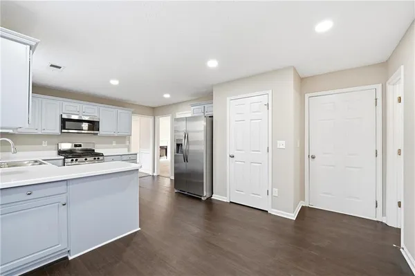 a kitchen with stainless steel appliances refrigerator stove microwave and cabinets