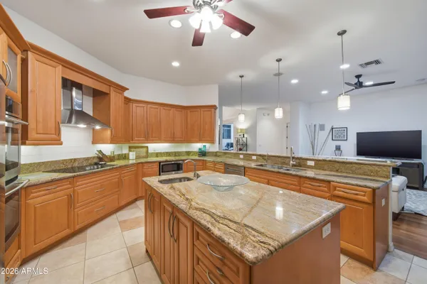 a kitchen with stainless steel appliances granite countertop a sink and a stove