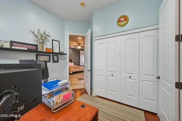a view of a hallway with workspace and a window
