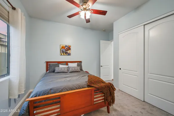 a bedroom with a bed and a chandelier