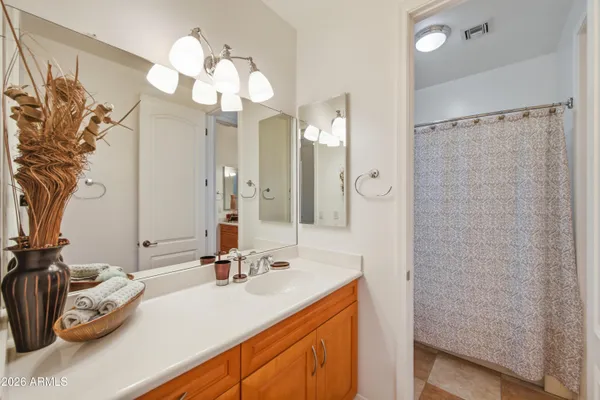 a bathroom with a sink a light fixture and a mirror