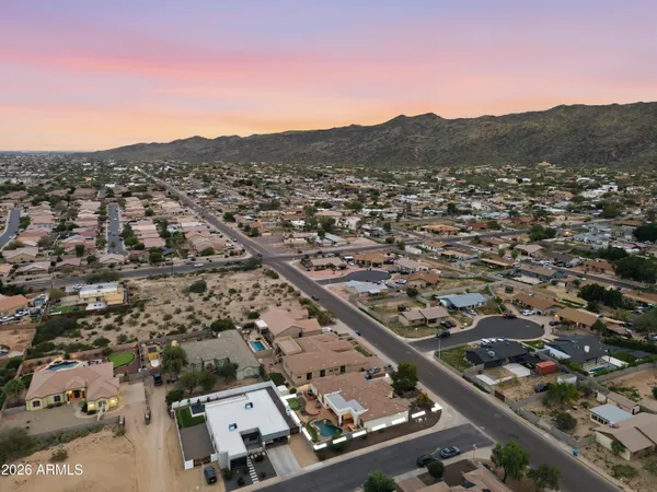 an aerial view of residential houses with city view