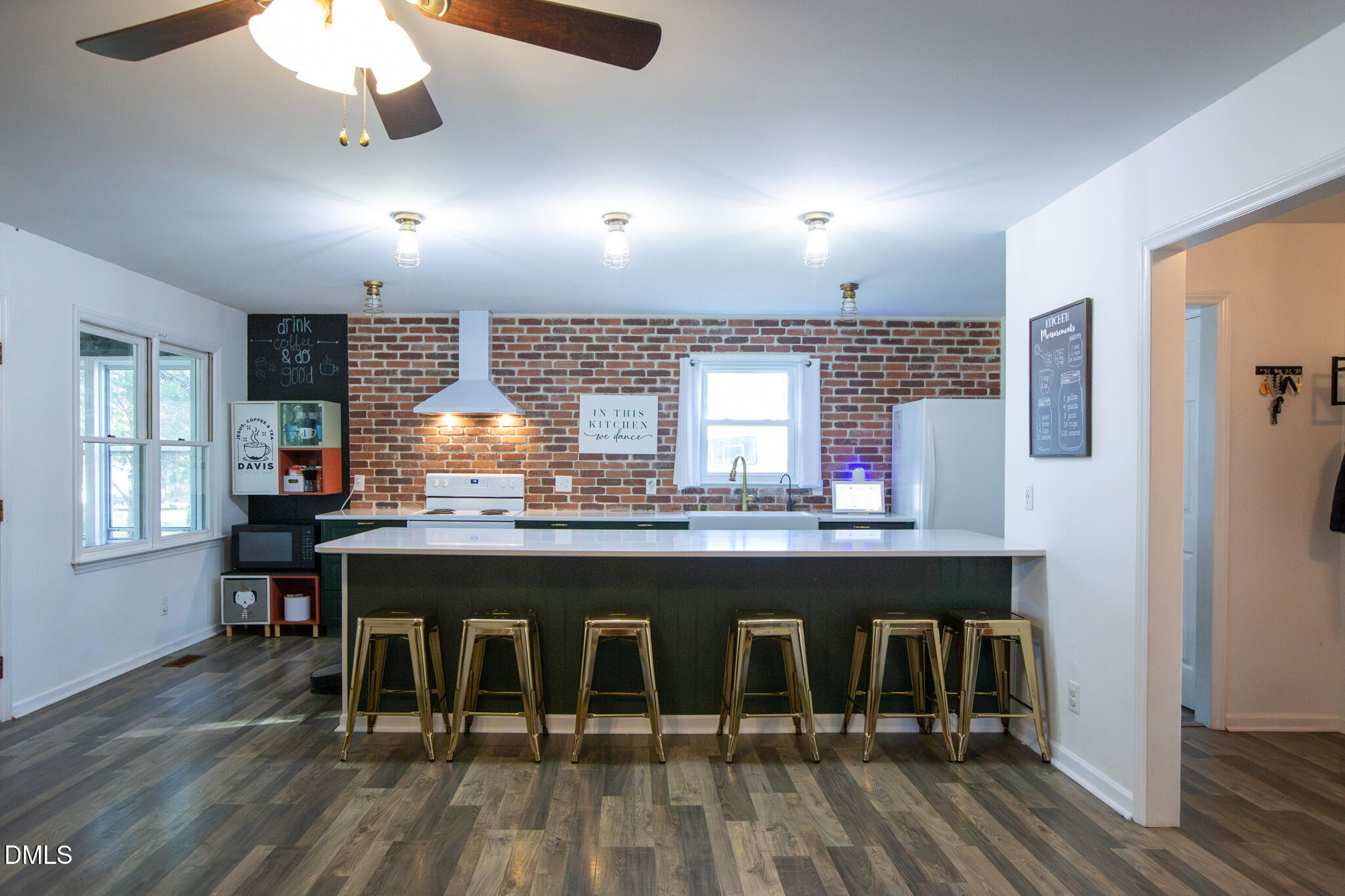 764 Corbett Road Clayton, NC 27520 - Photo 11 of 65 a kitchen with kitchen island granite countertop a table chairs sink and cabinets