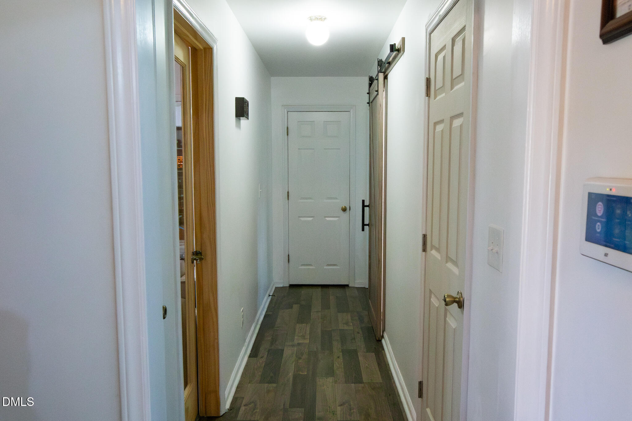 764 Corbett Road Clayton, NC 27520 - Photo 17 of 65 a view of a hallway with wooden floor and a bathroom