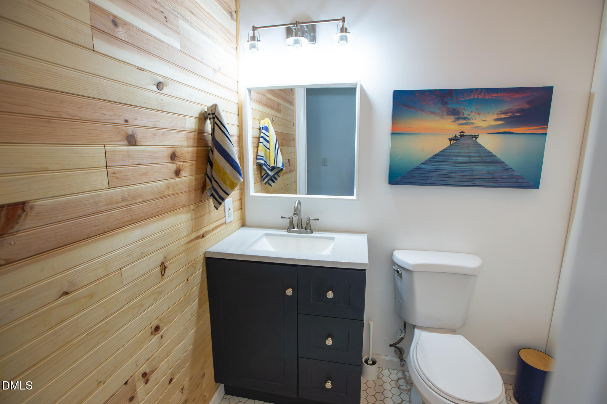 764 Corbett Road Clayton, NC 27520 - Photo 19 of 65 a bathroom with a toilet a sink and mirror