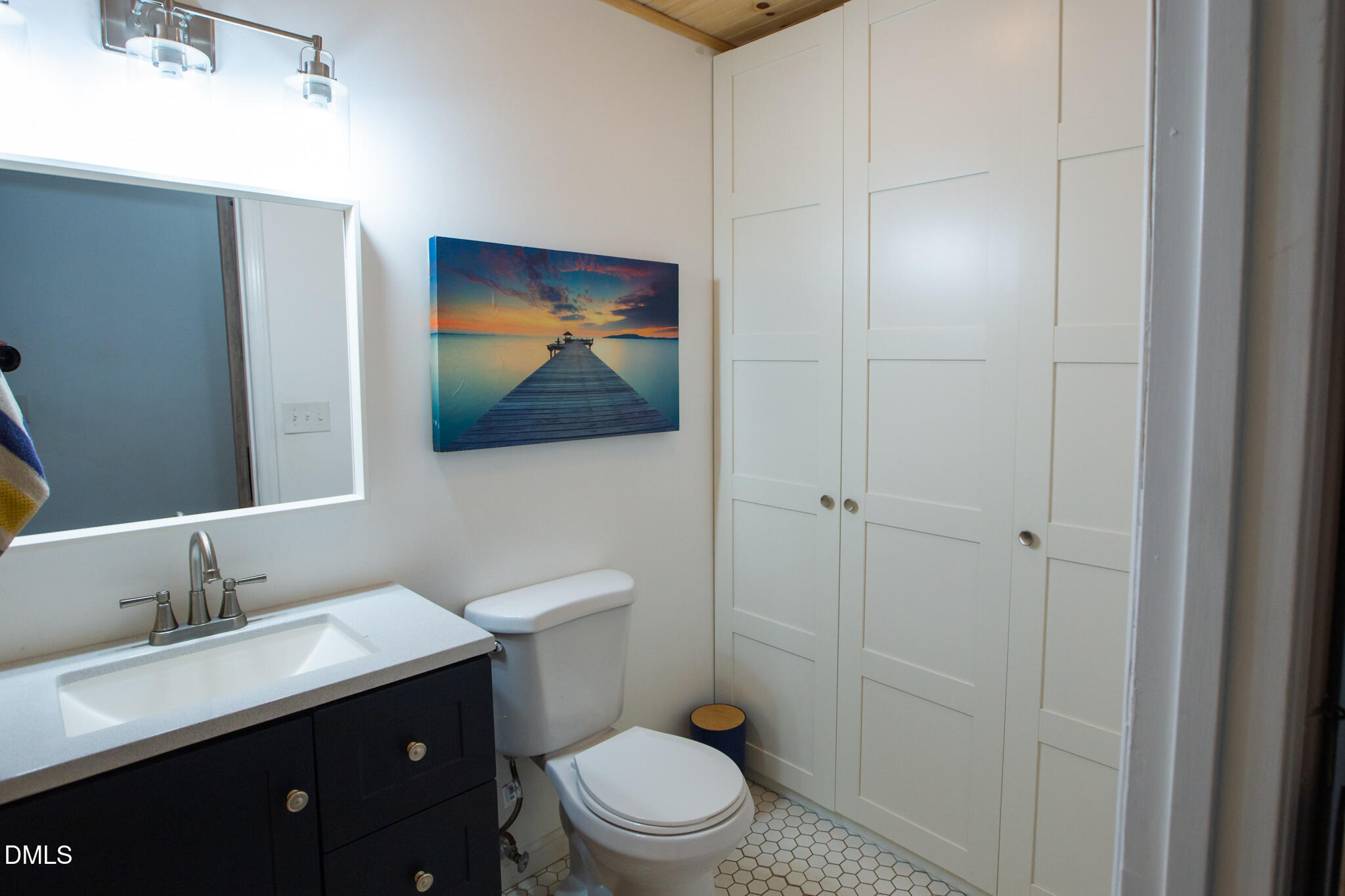 764 Corbett Road Clayton, NC 27520 - Photo 20 of 65 a bathroom with a toilet a sink and mirror