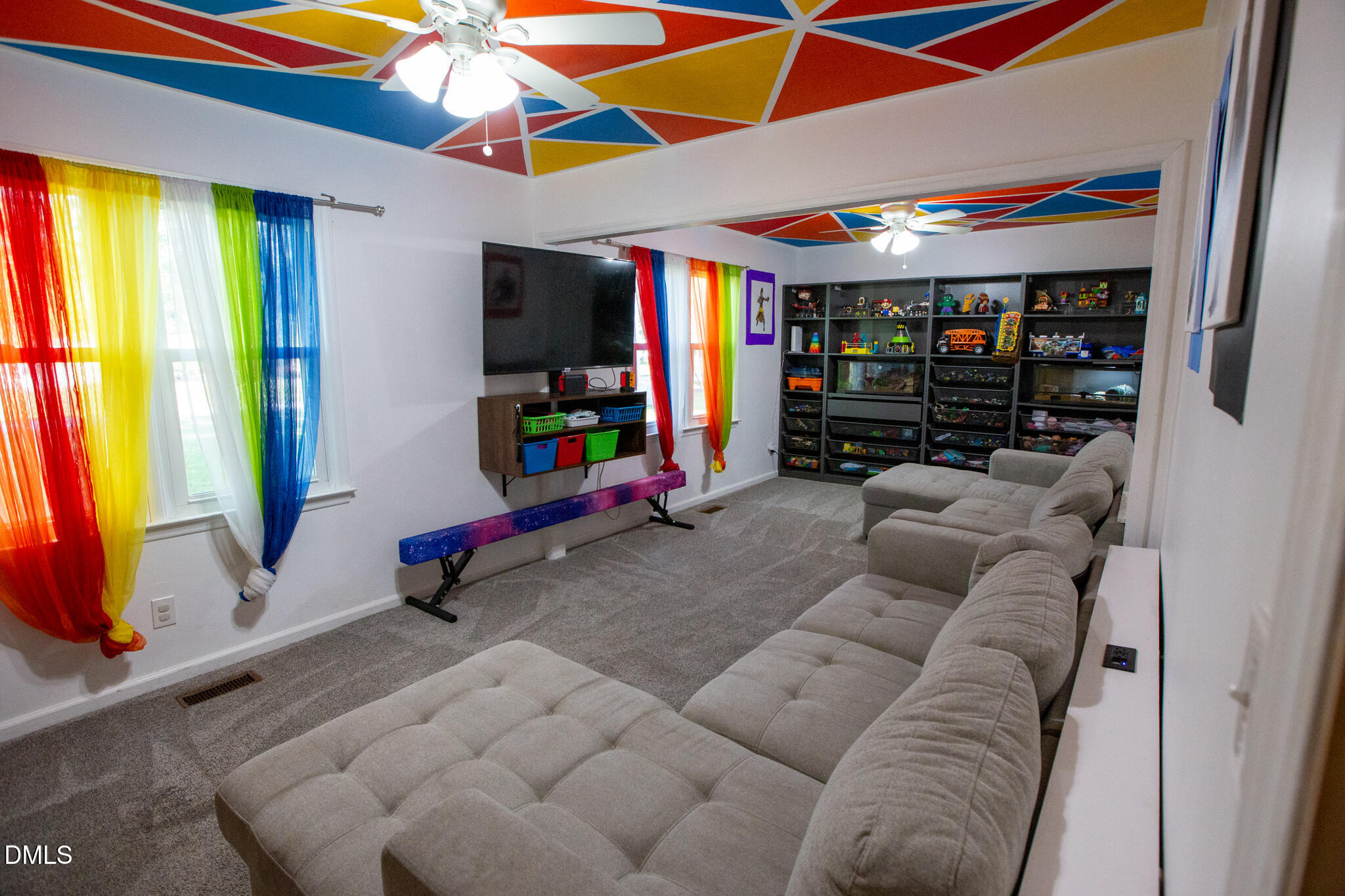 764 Corbett Road Clayton, NC 27520 - Photo 21 of 65 a living room with furniture and a flat screen tv