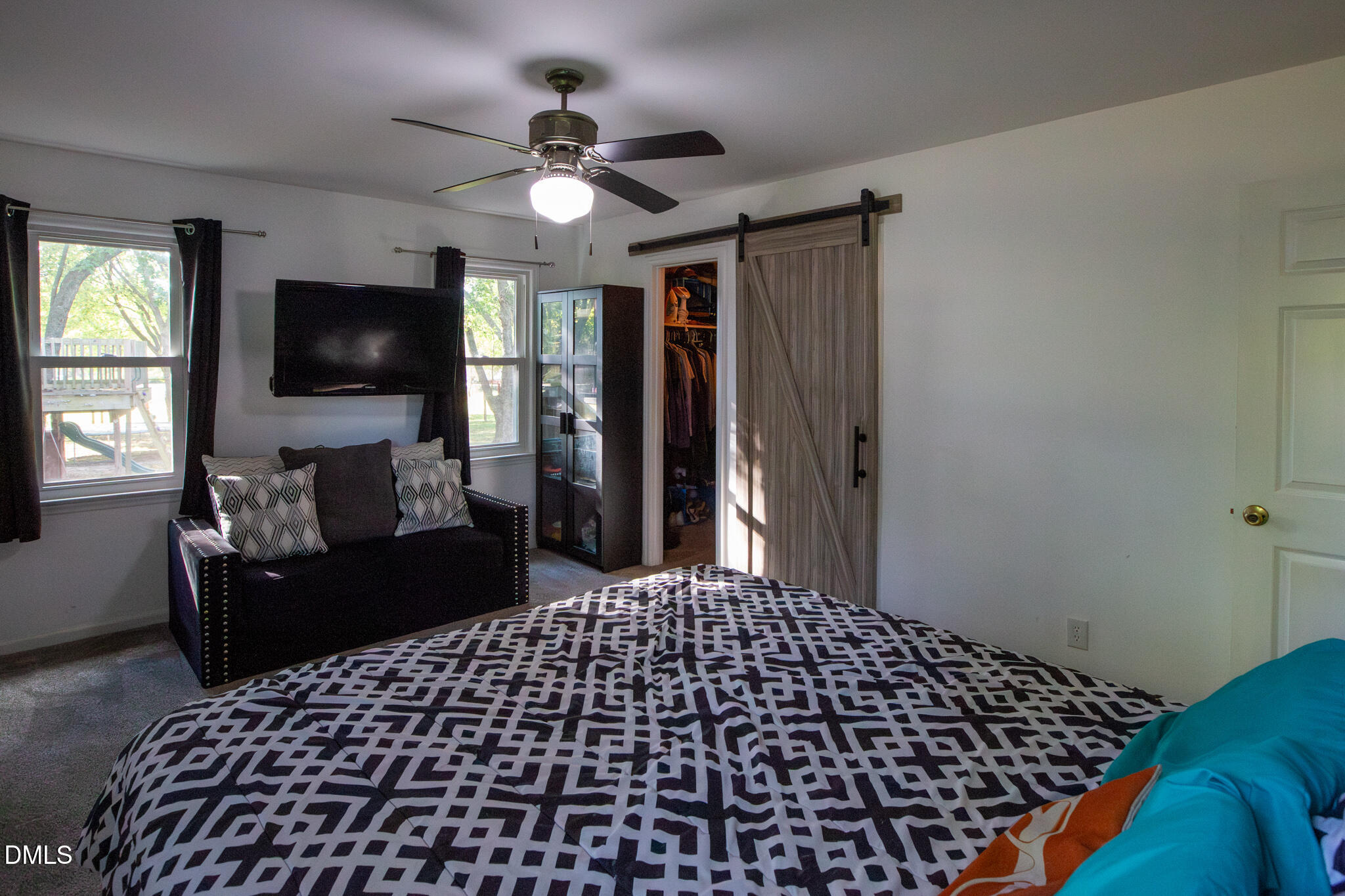 764 Corbett Road Clayton, NC 27520 - Photo 28 of 65 a bedroom with a bed and a flat tv screen