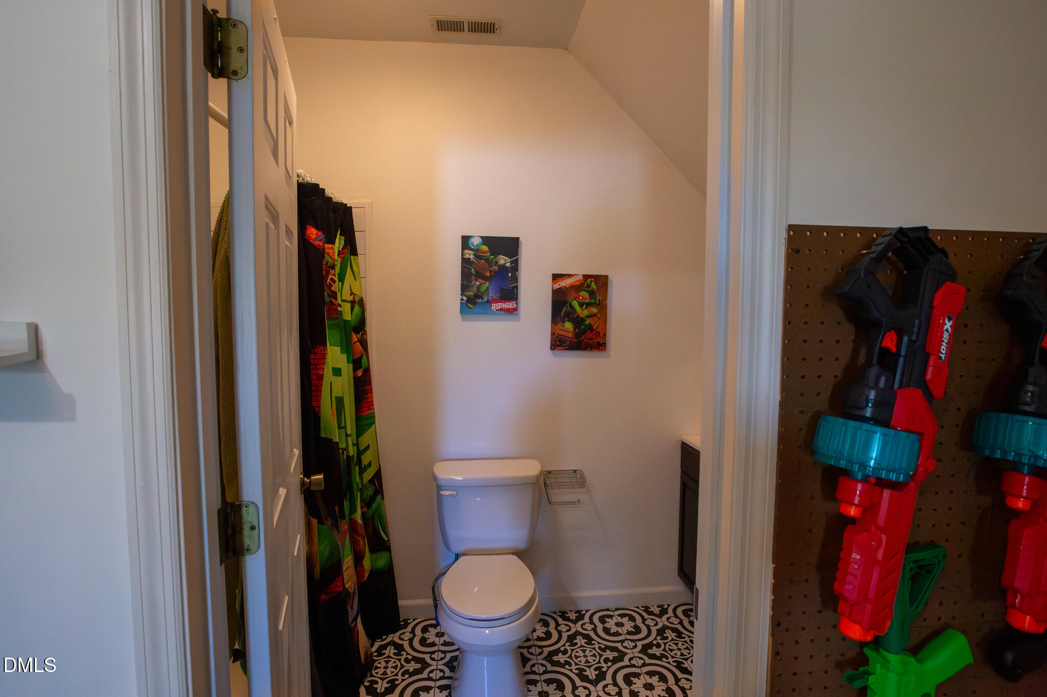 764 Corbett Road Clayton, NC 27520 - Photo 38 of 65 a bathroom with a toilet and a shower curtain