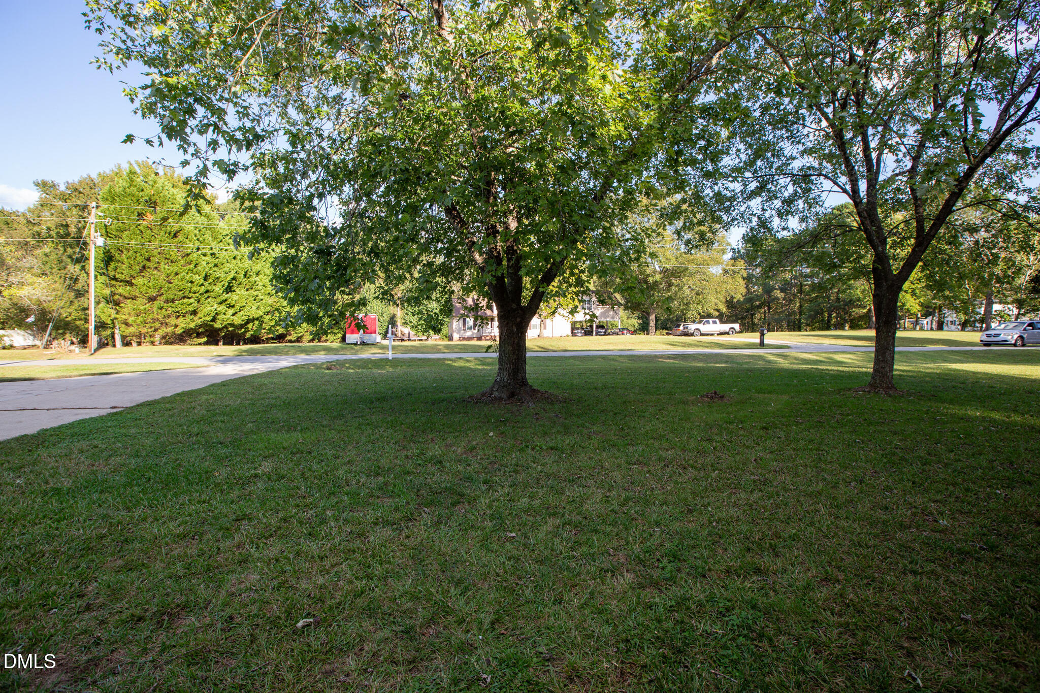 764 Corbett Road Clayton, NC 27520 - Photo 5 of 65 a view of grassy field with benches and trees all around