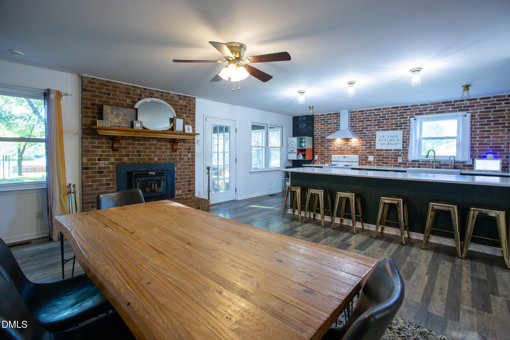 764 Corbett Road Clayton, NC 27520 - Photo 8 of 65 a open kitchen with kitchen island a stove and a wooden floors