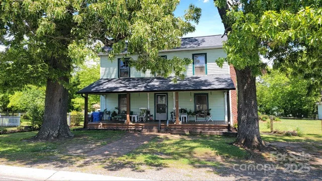 a view of a house with backyard porch and sitting area