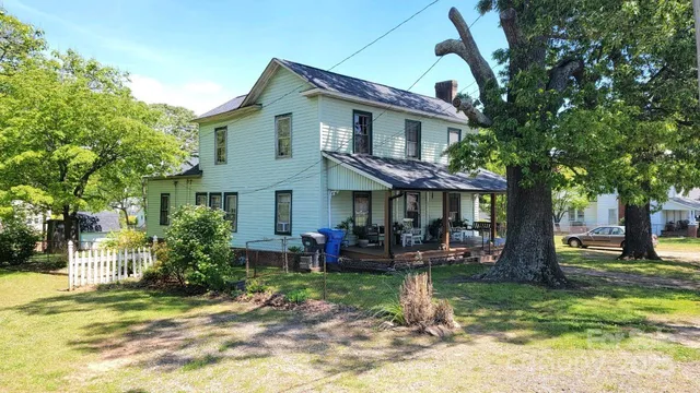 a view of a house with backyard porch and sitting area