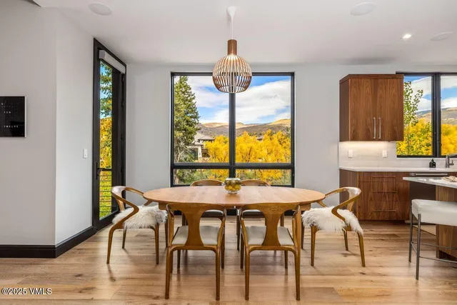a view of a balcony with two chairs and a potted plant