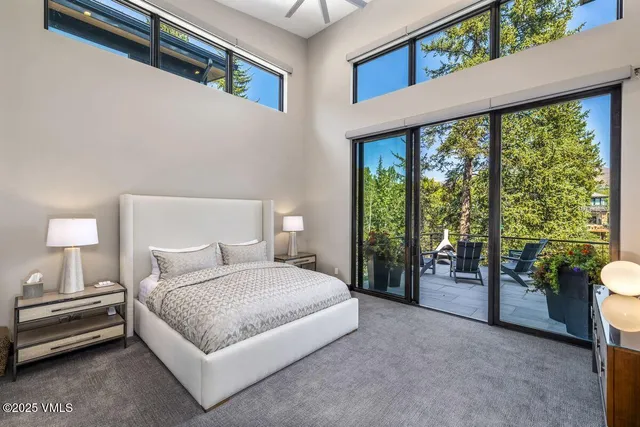 a spacious bedroom with a bed and a lamp