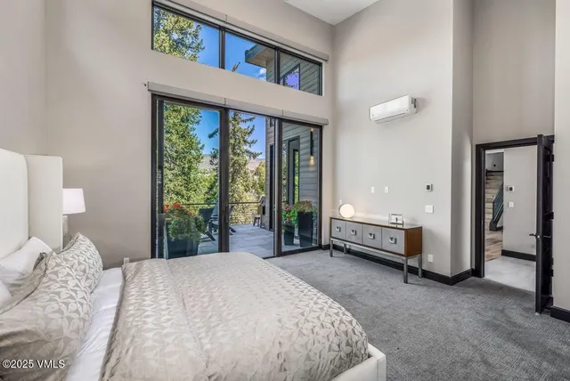a bathroom with a double vanity sink a mirror and a bathtub