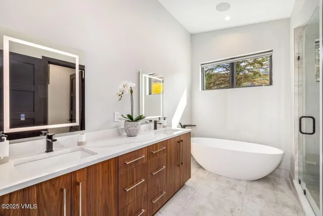 a bathroom with a granite countertop sink a toilet and a mirror