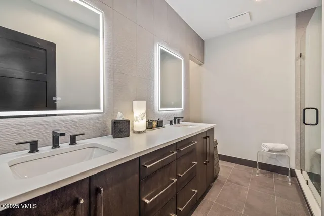 a bathroom with a granite countertop sink toilet and mirror