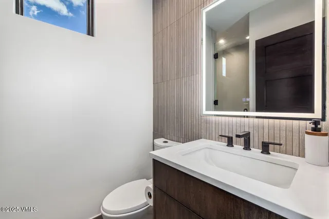 a view of a workspace with furniture and window