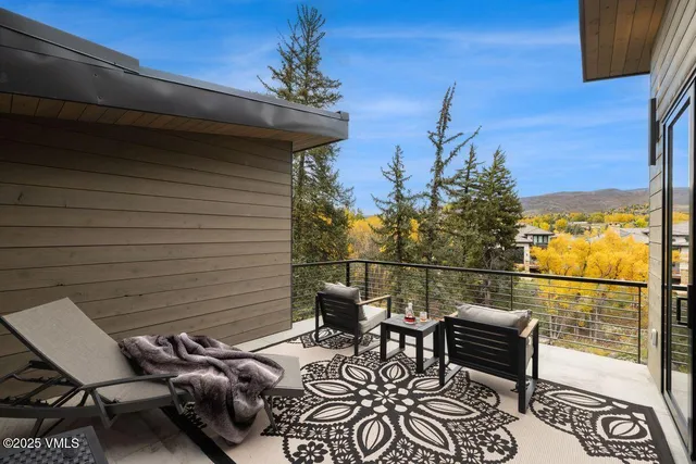 a view of a hallway view with wooden floor and living room
