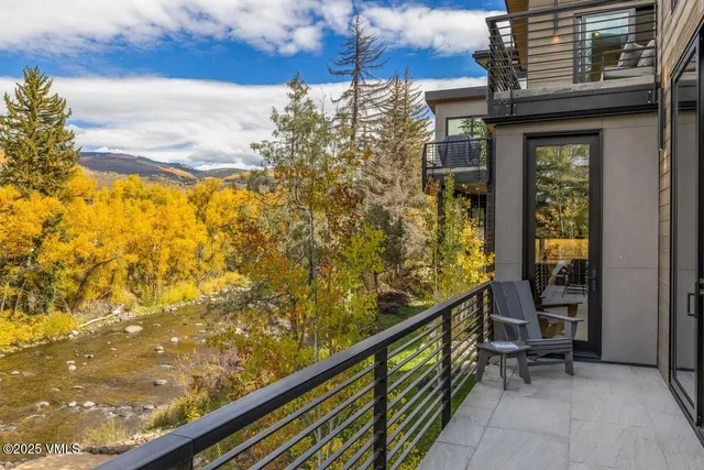 a backyard of a house with yard and outdoor seating