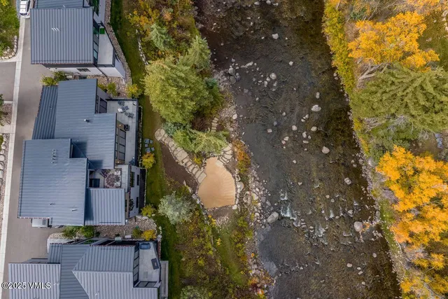 a view of a house with a snow in between yard and outdoor seating