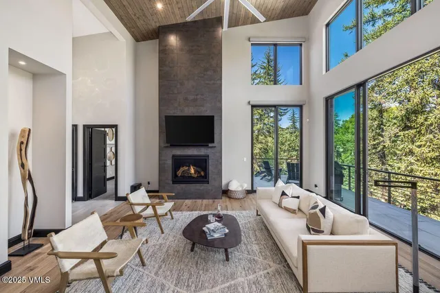 a kitchen with granite countertop a dining table chairs and wooden floor