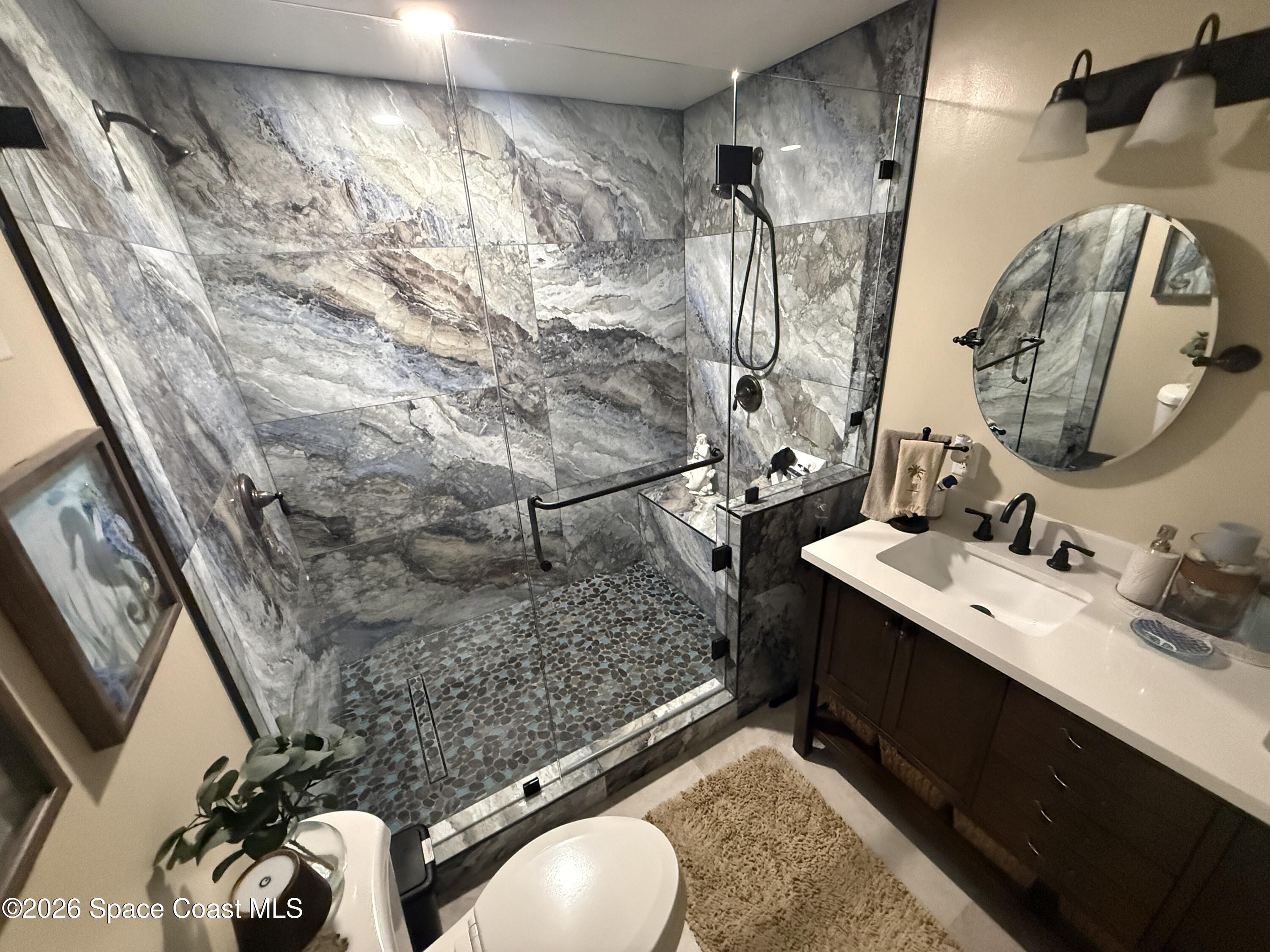 1908 Cedar Lane Melbourne Beach, FL 32951 - Photo 16 of 52 a bathroom with a sink mirror and vanity