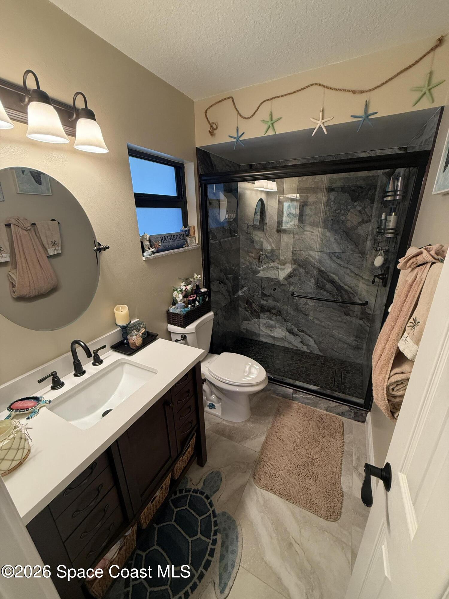 1908 Cedar Lane Melbourne Beach, FL 32951 - Photo 20 of 52 a bathroom with a sink vanity mirror and toilet