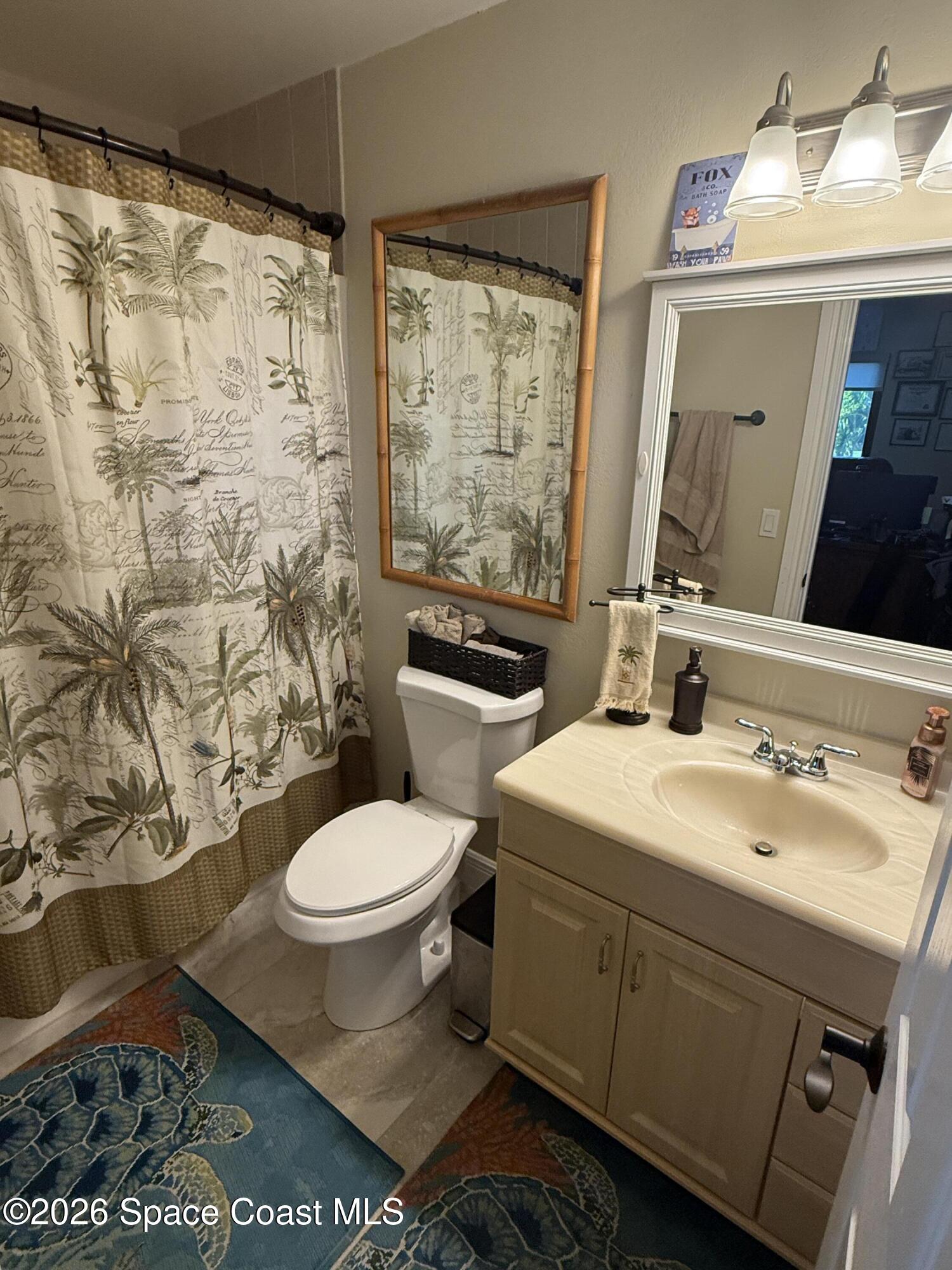 1908 Cedar Lane Melbourne Beach, FL 32951 - Photo 23 of 52 a bathroom with a sink toilet and shower