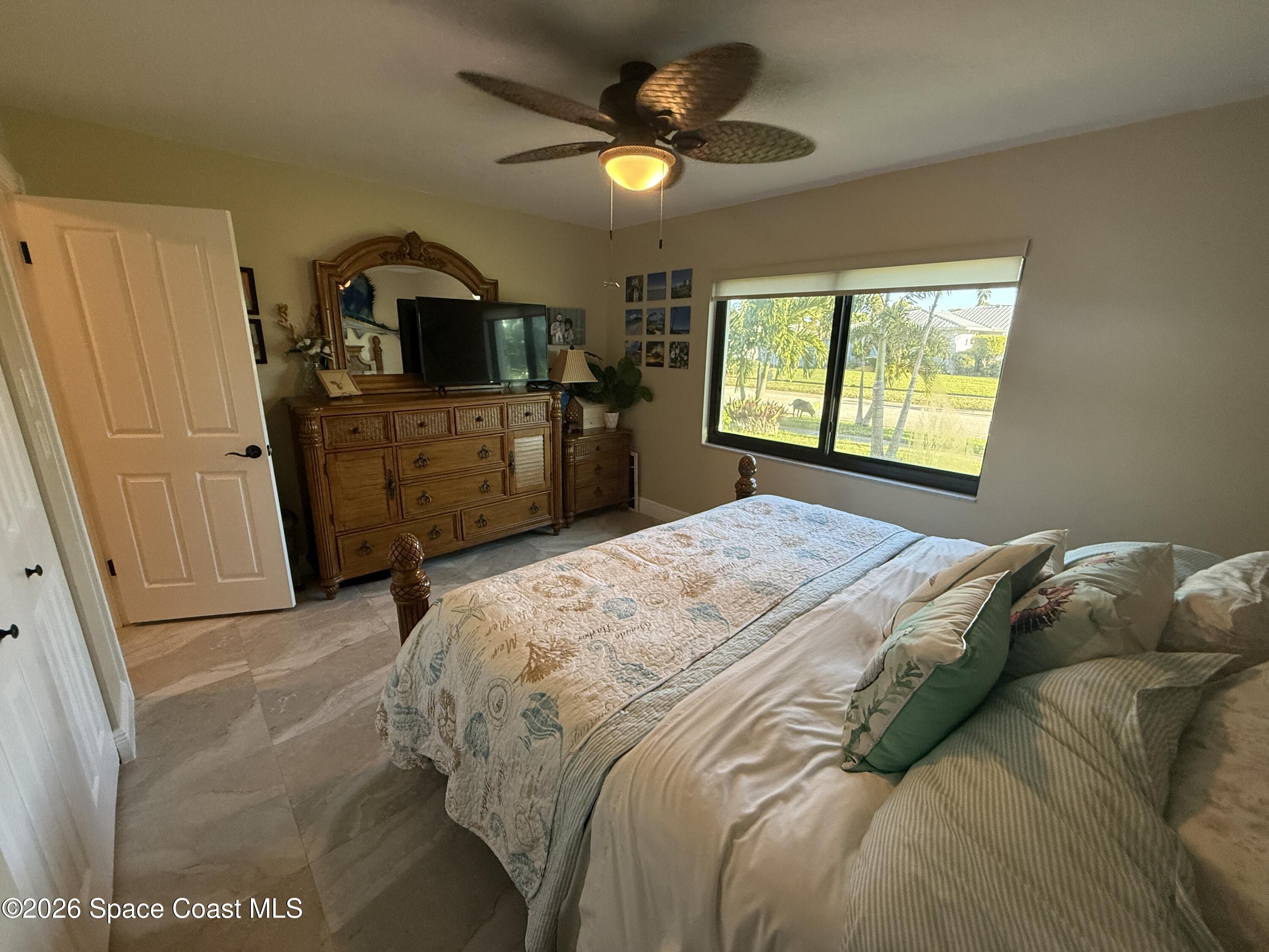 1908 Cedar Lane Melbourne Beach, FL 32951 - Photo 26 of 52 a bedroom with a bed and a television