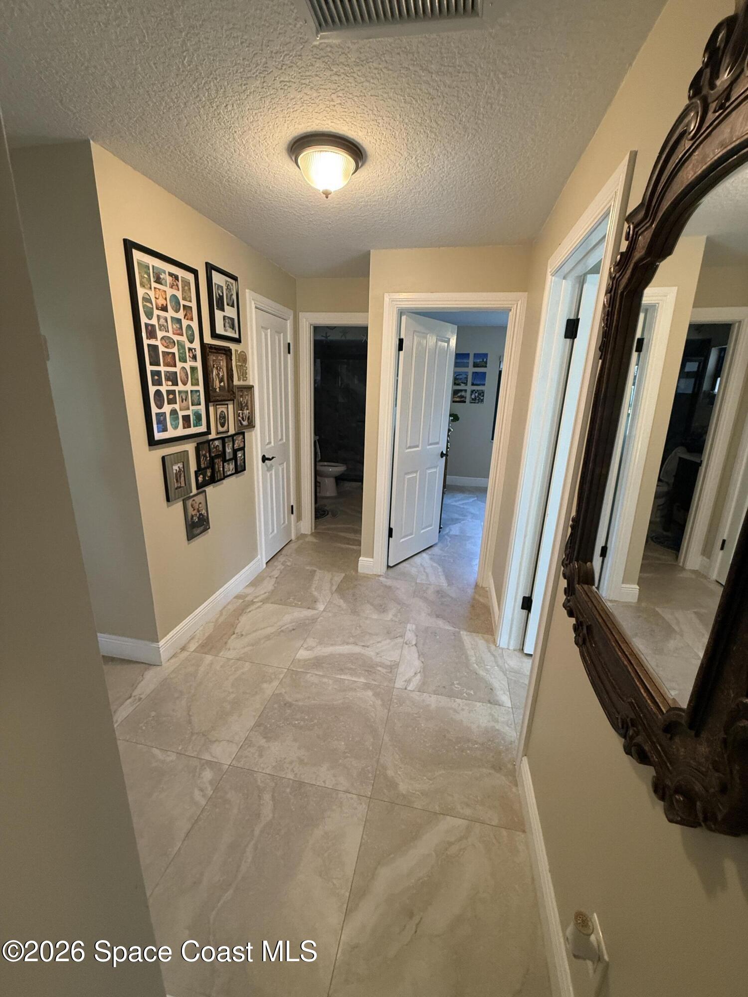 1908 Cedar Lane Melbourne Beach, FL 32951 - Photo 29 of 52 a view of a hallway with wooden floor and stairs