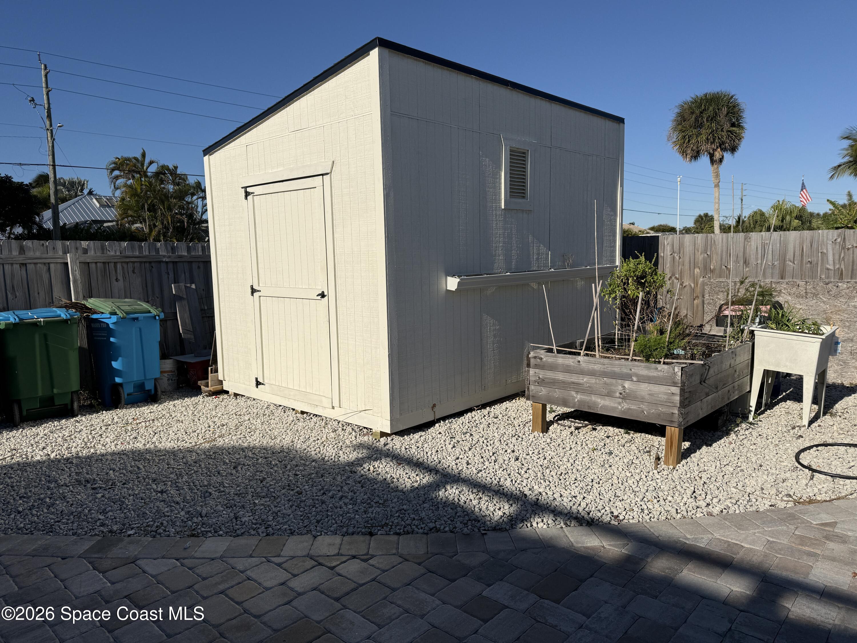 1908 Cedar Lane Melbourne Beach, FL 32951 - Photo 39 of 52 a wooden bench sitting in patio of a house