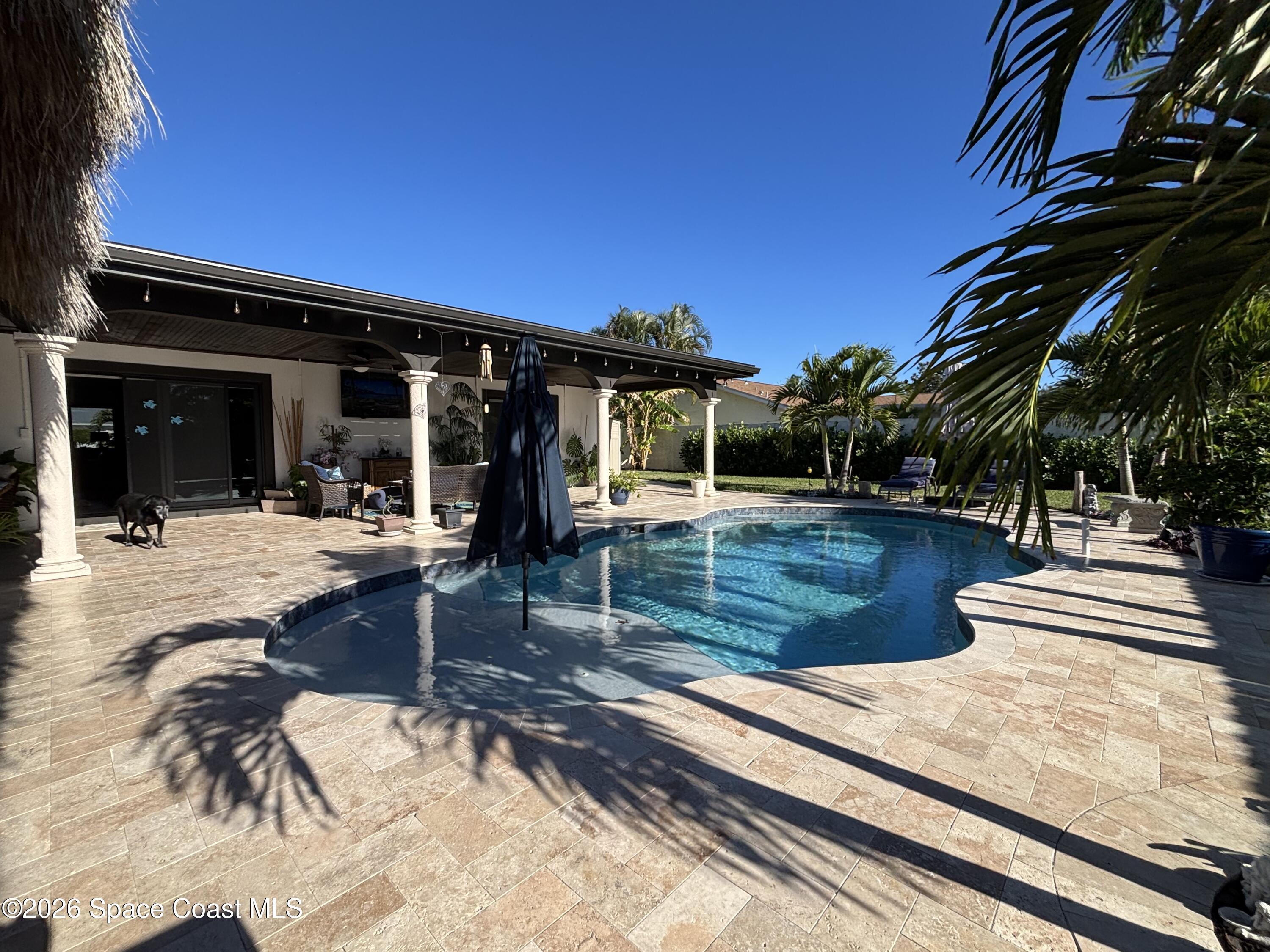 1908 Cedar Lane Melbourne Beach, FL 32951 - Photo 8 of 52 a view of a patio with swimming pool table and chairs