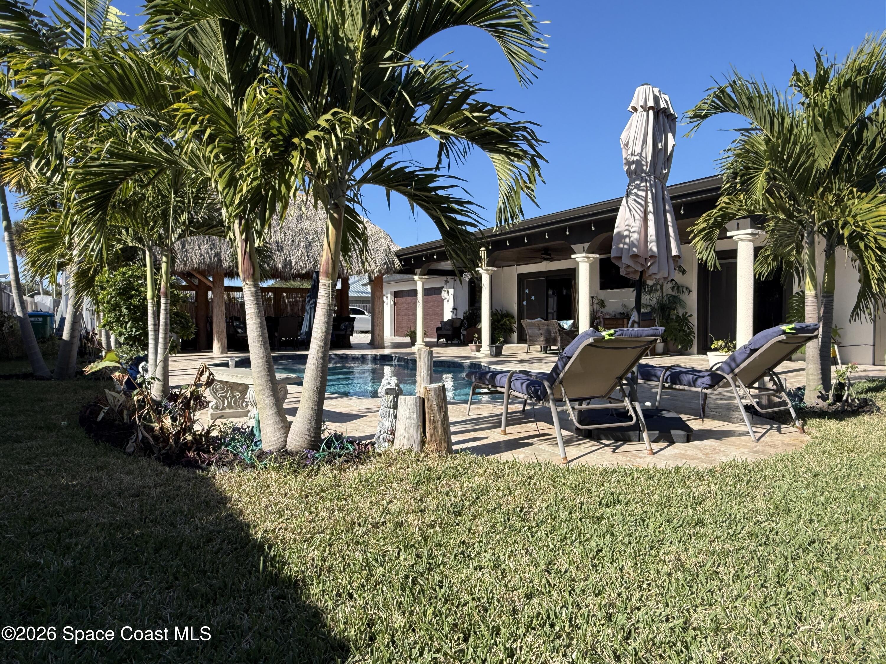 1908 Cedar Lane Melbourne Beach, FL 32951 - Photo 10 of 52 a view of a house with backyard porch and sitting area