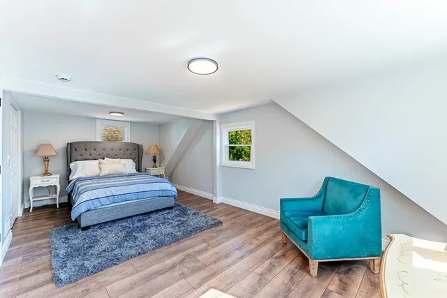 a bedroom with a bed and a mirror