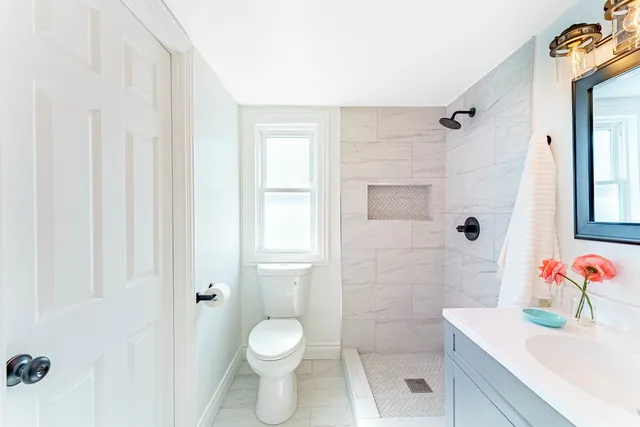 a bathroom with a sink toilet and shower